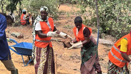 Women moving rocks for filter dam