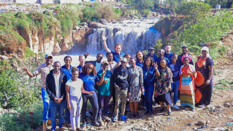 Group photo of the World Waternet team with some of the drivers that shape the future of the Mathare River ecosystem including NCWSC, WRA, waste managers, community leaders and youth and elderly representatives. On the background the Mau Mau falls just af